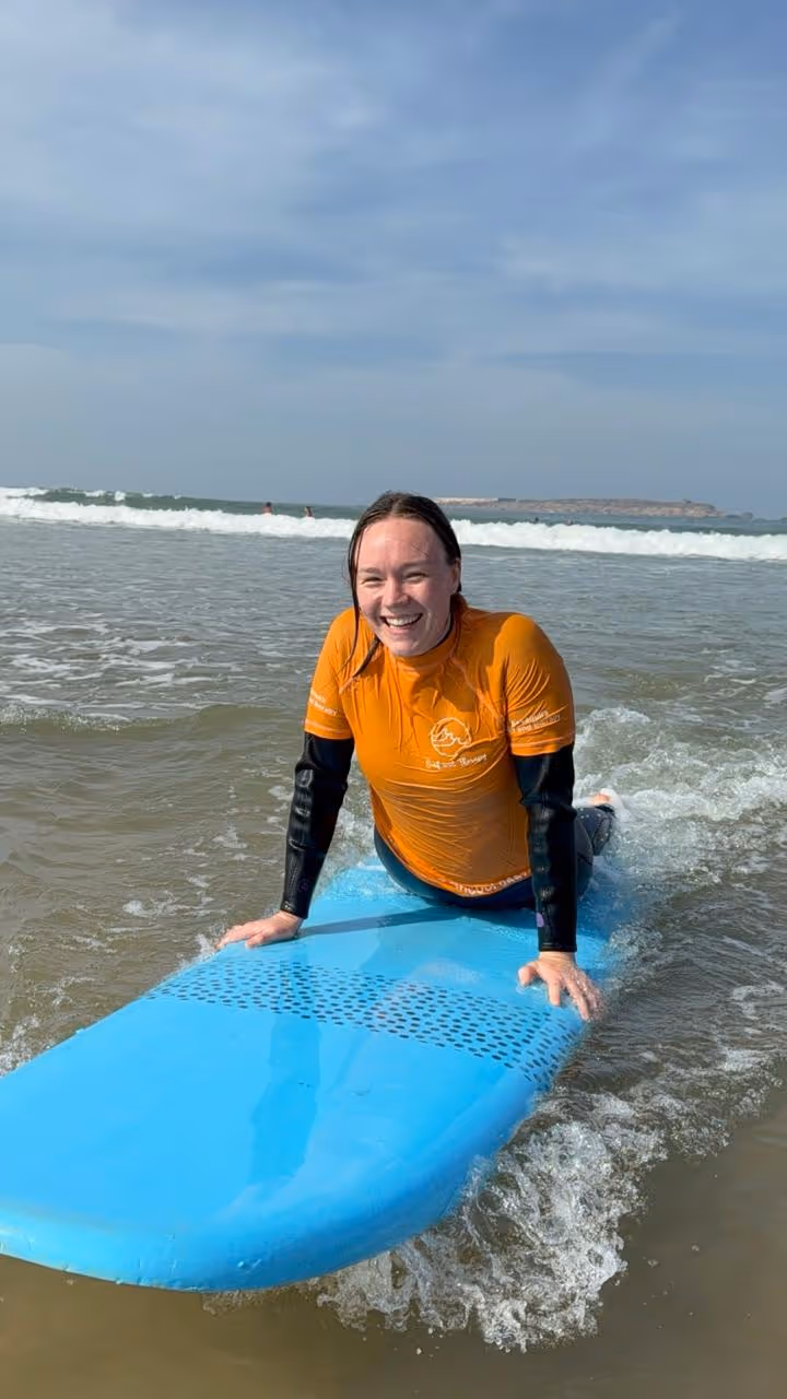 Chaimae surfing a wave on the Atlantic coast near Essaouira